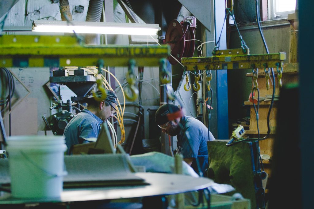 Two metal workers in a factory.
